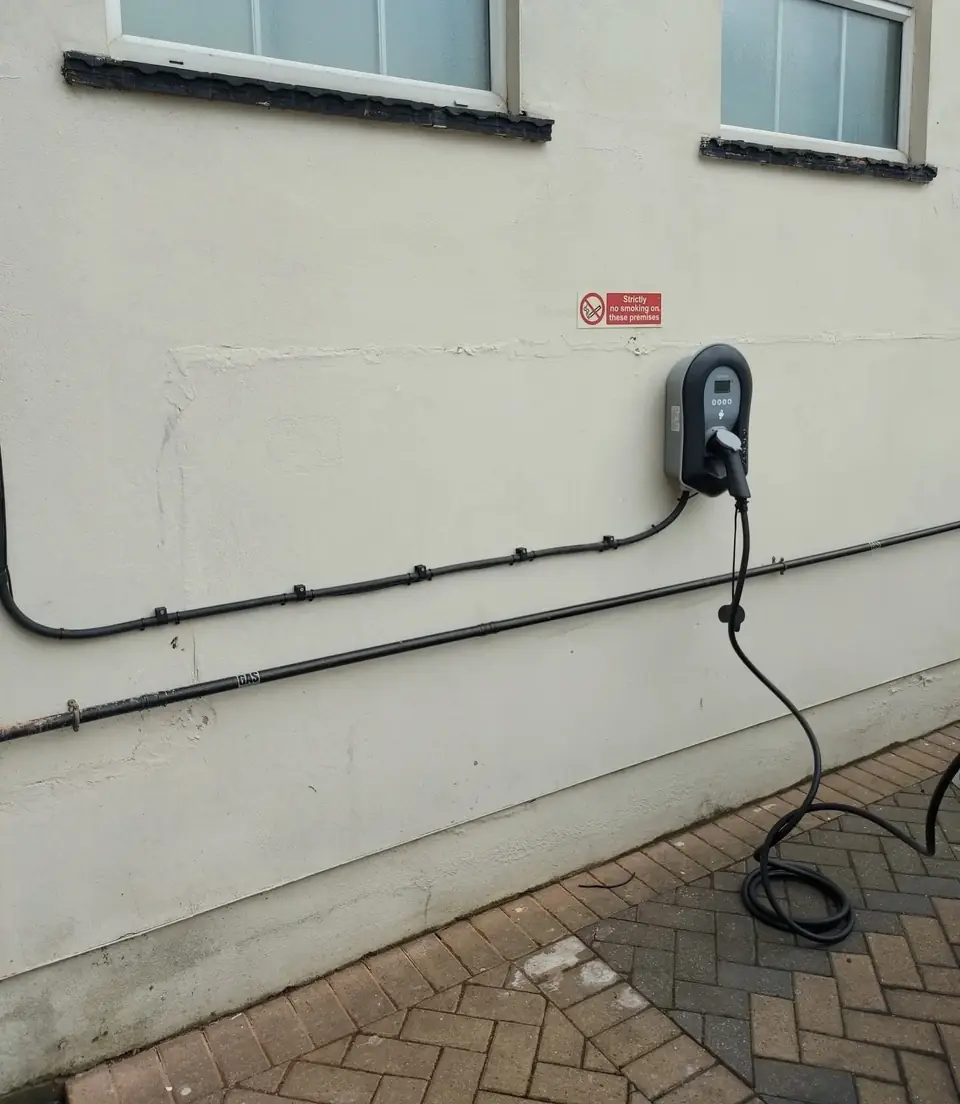 Electric car charger fitted by Jason Church Electrical on a rendered wall